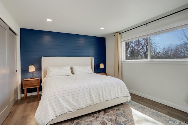 bedroom featuring recessed lighting, a closet, baseboards, and wood finished floors