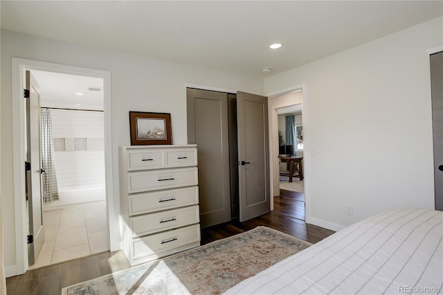 bedroom featuring recessed lighting, dark wood-style flooring, connected bathroom, and baseboards