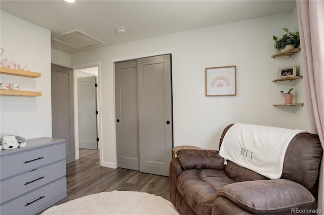 sitting room featuring attic access and dark wood-type flooring