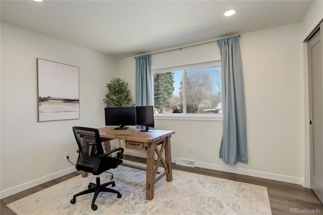 office featuring baseboards, visible vents, wood finished floors, and recessed lighting