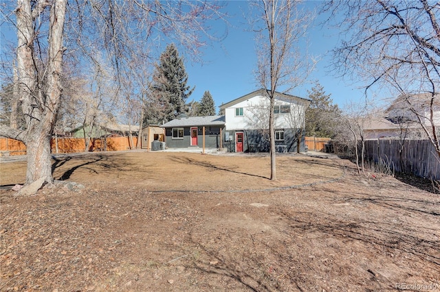 rear view of property featuring fence