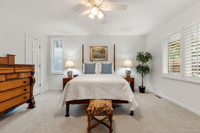 carpeted bedroom with baseboards and a ceiling fan