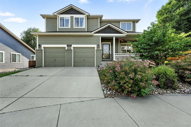 6039 Quay Ct, Arvada, CO 80003 - view of front of home with driveway, a porch, an attached garage, and brick siding