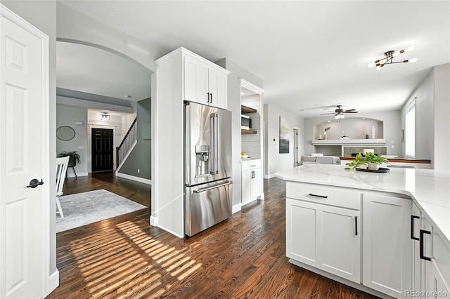 6039 Quay Ct, Arvada, CO 80003 - kitchen featuring high end refrigerator, a ceiling fan, dark wood-type flooring, white cabinetry, and arched walkways