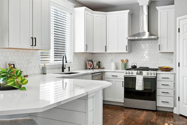 6039 Quay Ct, Arvada, CO 80003 - kitchen featuring gas range, wall chimney exhaust hood, healthy amount of natural light, and white cabinets