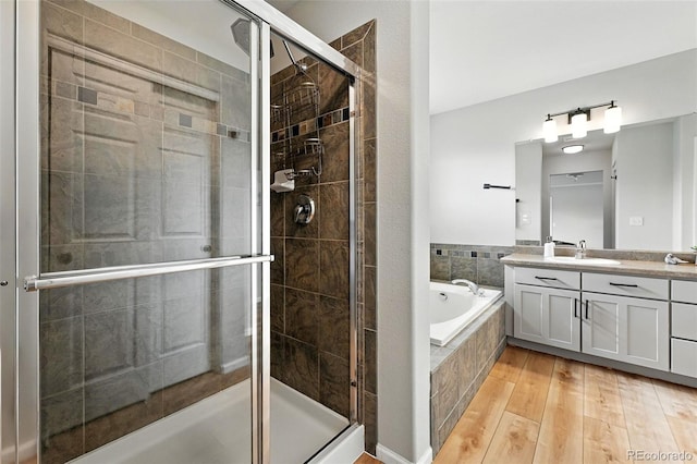 6039 Quay Ct, Arvada, CO 80003 - full bath with vanity, a garden tub, a shower stall, and wood finished floors