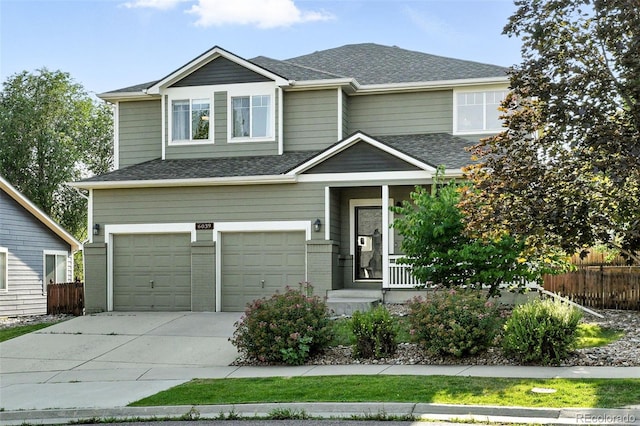 6039 Quay Ct, Arvada, CO 80003 - view of front of property with concrete driveway, an attached garage, covered porch, and a shingled roof