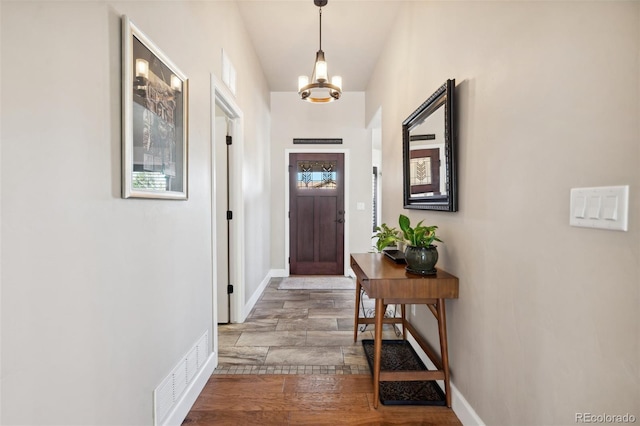 12441 Woodruff Dr, Colorado Springs, CO 80921 - doorway to outside with a chandelier, baseboards, and wood finished floors
