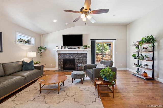 12441 Woodruff Dr, Colorado Springs, CO 80921 - living area featuring a fireplace, wood finished floors, lofted ceiling, a ceiling fan, and baseboards