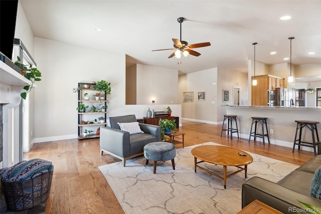 12441 Woodruff Dr, Colorado Springs, CO 80921 - living room with light wood-type flooring, ceiling fan, baseboards, and recessed lighting
