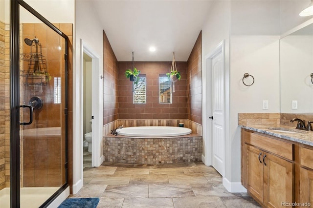 12441 Woodruff Dr, Colorado Springs, CO 80921 - bathroom with a shower stall, vanity, toilet, a garden tub, and recessed lighting