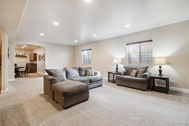 12441 Woodruff Dr, Colorado Springs, CO 80921 - living area with light carpet, arched walkways, baseboards, and recessed lighting