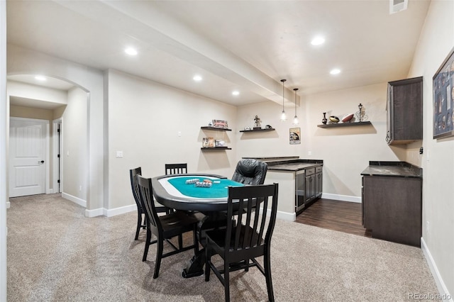 12441 Woodruff Dr, Colorado Springs, CO 80921 - dining room with dark carpet, recessed lighting, arched walkways, baseboards, and bar