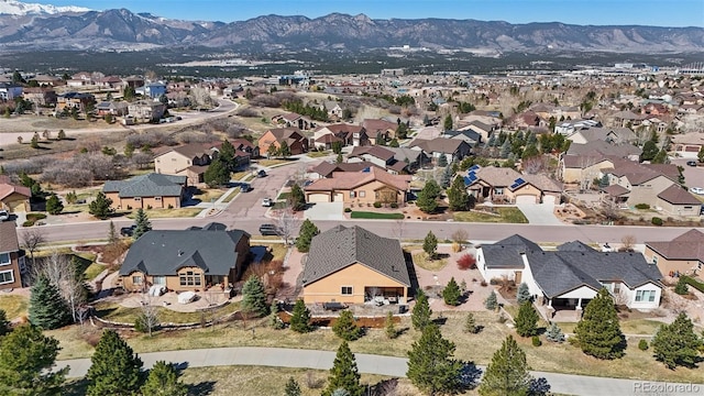 12441 Woodruff Dr, Colorado Springs, CO 80921 - aerial overview of property's location with nearby suburban area and a mountain backdrop