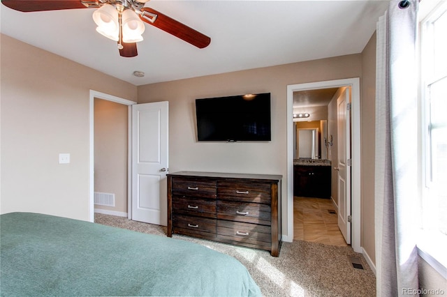 bedroom featuring light colored carpet, ceiling fan, and visible vents