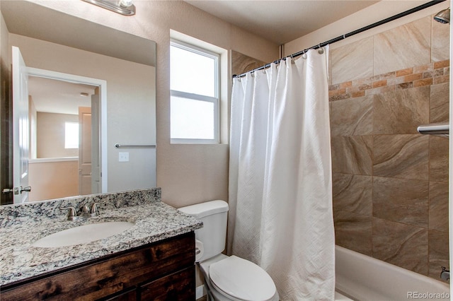 bathroom featuring toilet, shower / bath combo, and vanity