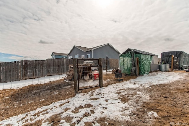 snowy yard with fence