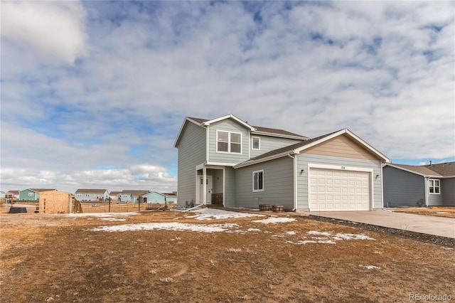 view of front of property featuring an attached garage, a residential view, and concrete driveway