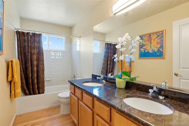 21395 E Greenwood Pl, Aurora, CO 80013 - bathroom with wood finished floors, shower / bath combination with curtain, toilet, and double vanity