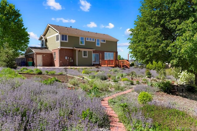21395 E Greenwood Pl, Aurora, CO 80013 - rear view of house featuring a wooden deck and brick siding