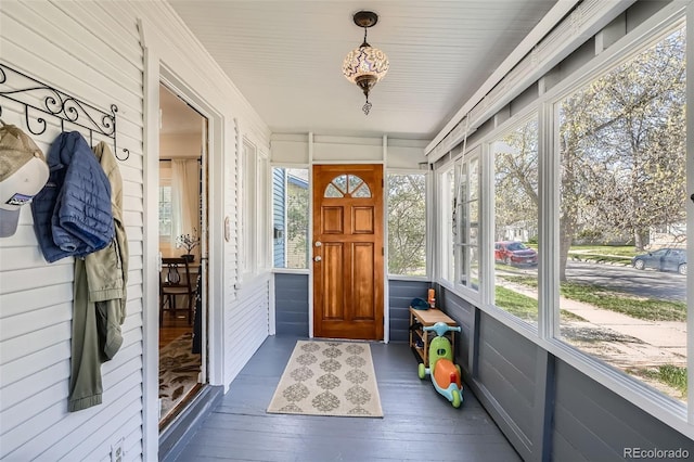 sunroom / solarium featuring wood-type flooring
