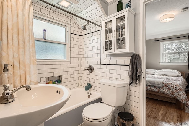 full bathroom with a sink, toilet, ensuite bathroom, wood finished floors, and visible vents