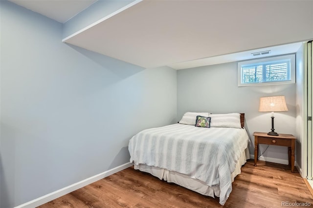 bedroom featuring visible vents, baseboards, and light wood-type flooring
