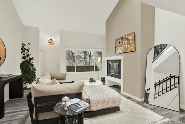 8055 E Colorado Ave Unit 8, Denver, CO 80231 - living area featuring wood finished floors, stairway, vaulted ceiling, and a fireplace