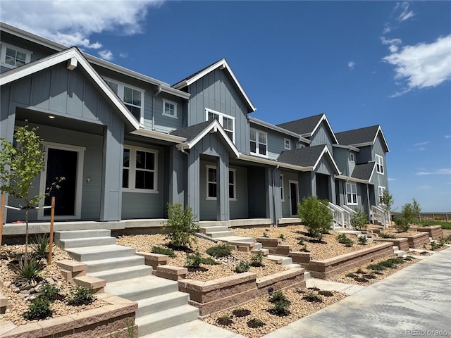 17137 W 91st Ln, Arvada, CO 80007 - view of front of property with board and batten siding, covered porch, and roof with shingles