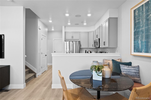 17137 W 91st Ln, Arvada, CO 80007 - dining space with light wood-type flooring, stairway, and recessed lighting