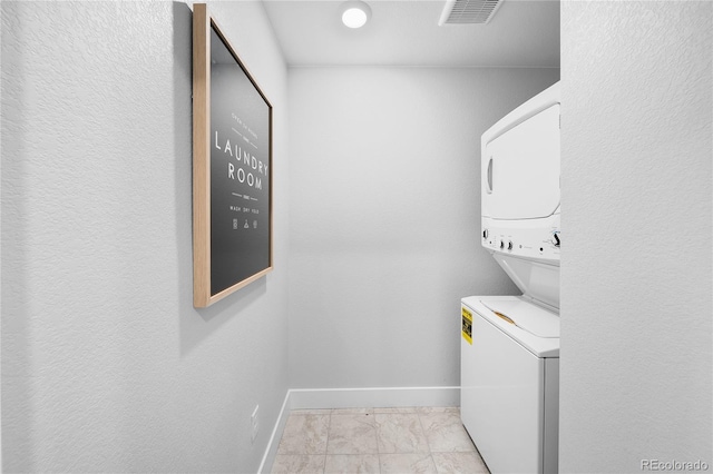17137 W 91st Ln, Arvada, CO 80007 - laundry area with stacked washer / drying machine and light marble finish flooring