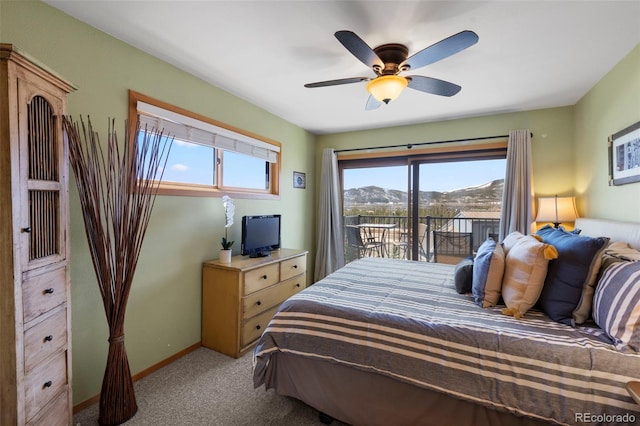 bedroom featuring access to exterior, light colored carpet, baseboards, and a ceiling fan