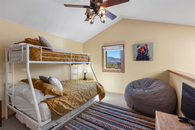 bedroom with carpet floors, vaulted ceiling, a ceiling fan, and baseboards