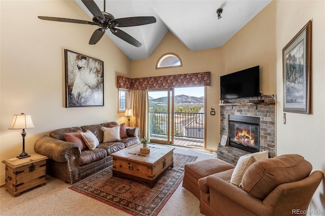 living room featuring a fireplace, carpet, a ceiling fan, and high vaulted ceiling