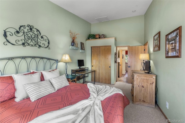 bedroom featuring carpet, attic access, and baseboards