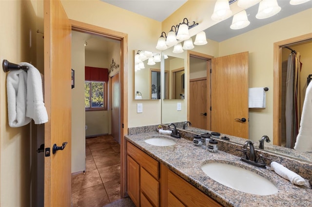 bathroom with tile patterned flooring and double vanity