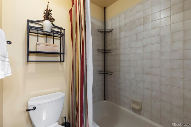 bathroom featuring shower / bath combo with shower curtain and toilet