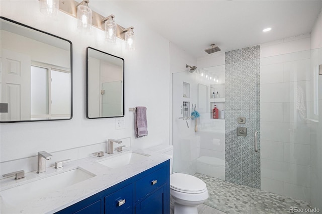 full bath featuring a sink, a shower stall, and toilet