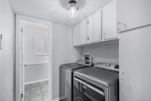 washroom with cabinet space and washer and clothes dryer