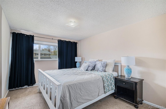carpeted bedroom with baseboards and a textured ceiling