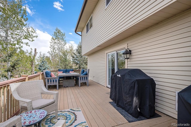 wooden deck featuring outdoor dining area, a grill, and an outdoor living space