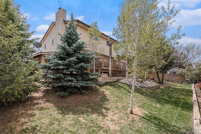 view of yard featuring fence and a wooden deck