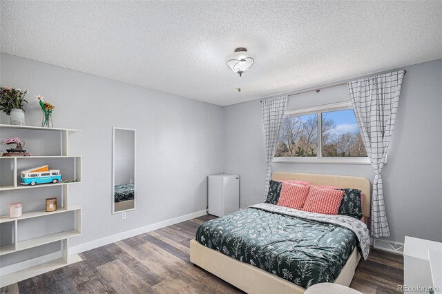 92 Helena Cir, Littleton, CO 80124 - bedroom with wood finished floors, a textured ceiling, and baseboards