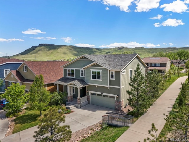 19782 W 59th Ave, Golden, CO 80403 - craftsman house with a mountain view, stone siding, concrete driveway, and a garage