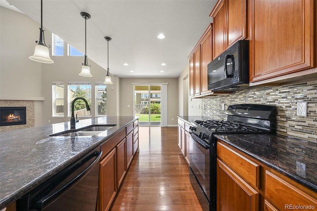 19782 W 59th Ave, Golden, CO 80403 - kitchen with black appliances, a sink, plenty of natural light, brown cabinetry, and recessed lighting