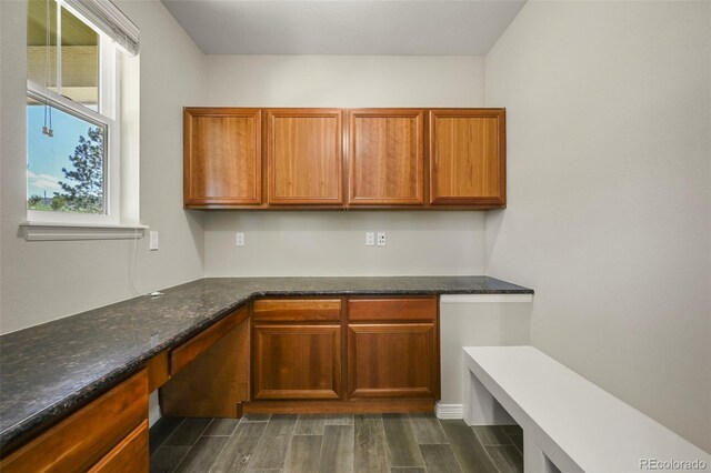 19782 W 59th Ave, Golden, CO 80403 - kitchen featuring dark wood-style floors, brown cabinetry, and dark stone counters