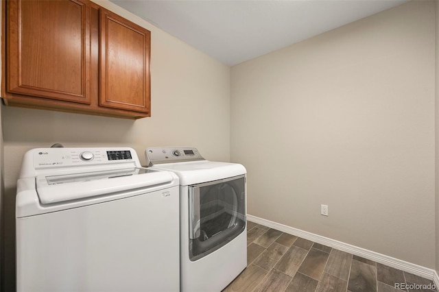 19782 W 59th Ave, Golden, CO 80403 - laundry room featuring cabinet space, washing machine and clothes dryer, wood finish floors, and baseboards