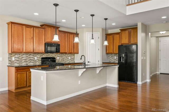 19782 W 59th Ave, Golden, CO 80403 - kitchen featuring black appliances, a sink, brown cabinetry, dark wood-style flooring, and backsplash