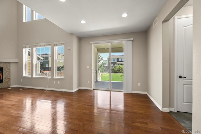 19782 W 59th Ave, Golden, CO 80403 - unfurnished living room with a fireplace, healthy amount of natural light, hardwood / wood-style flooring, baseboards, and recessed lighting