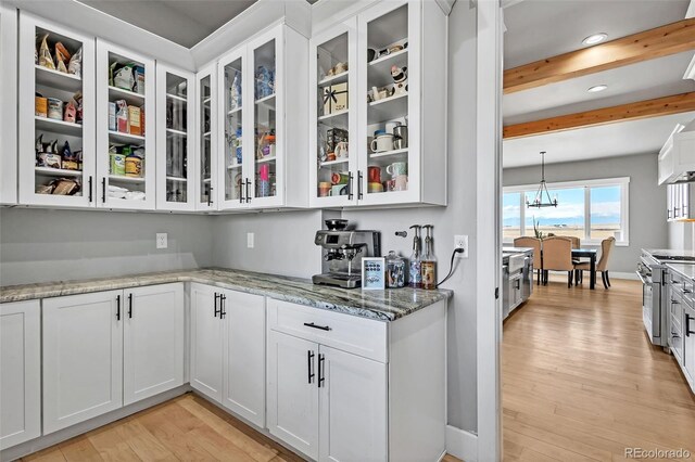 7668 Buckskin Ranch Vw, Peyton, CO 80831 - bar with light wood-style flooring, recessed lighting, a notable chandelier, beamed ceiling, and high end range